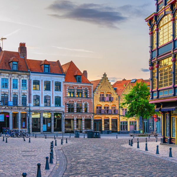 Vieux Lille old town quarter with empty narrow cobblestone street, paving stone square with old colorful buildings in historical city centre, French Flanders, Hauts-de-France Region, Northern France